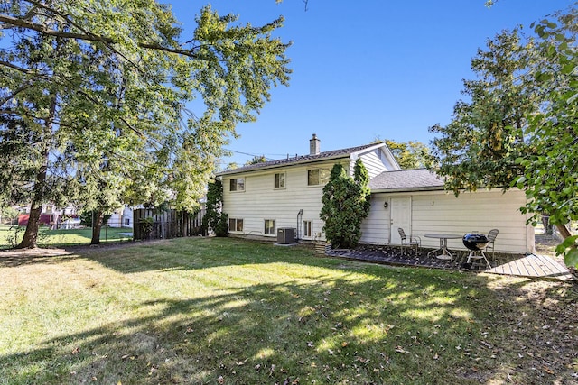 rear view of property featuring a lawn