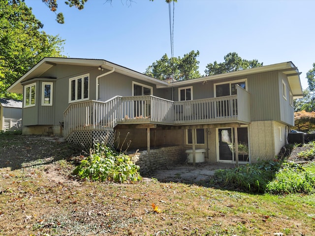 back of property featuring a wooden deck