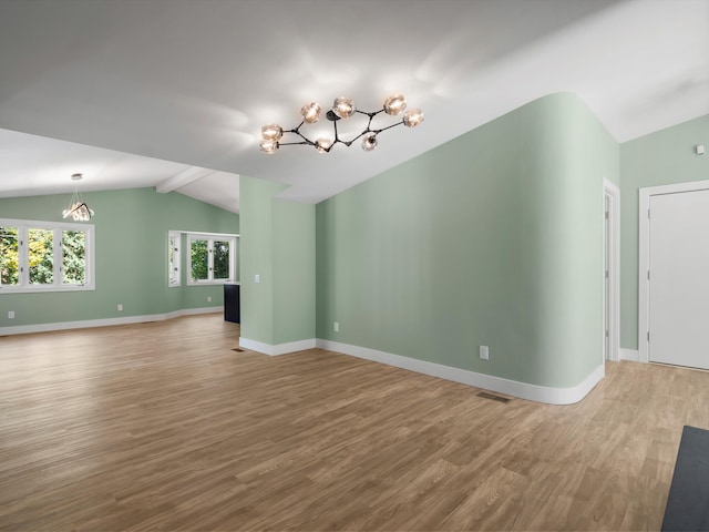 unfurnished living room featuring hardwood / wood-style flooring and vaulted ceiling