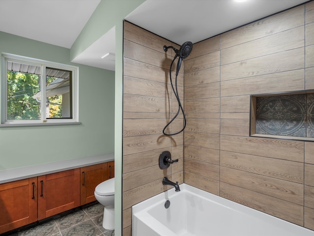 bathroom with wooden walls, tiled shower / bath combo, and toilet