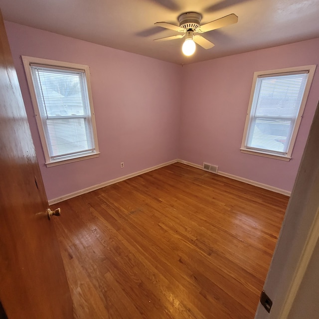 empty room with ceiling fan and wood-type flooring