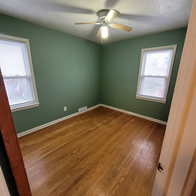 unfurnished room with wood-type flooring and ceiling fan