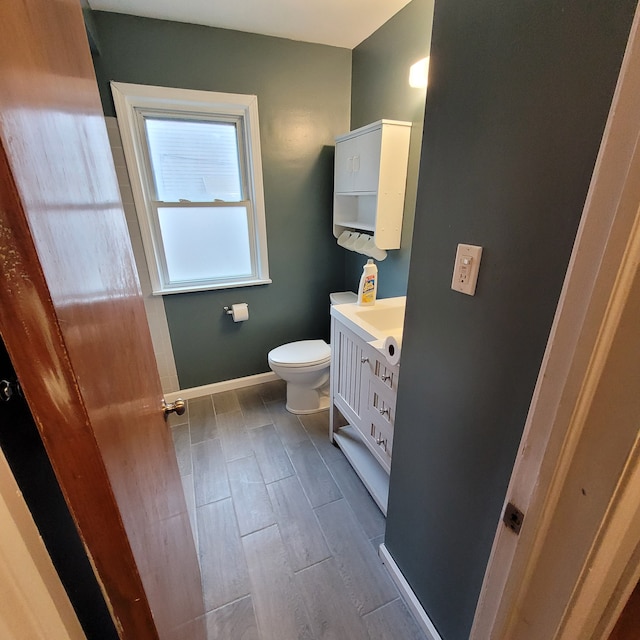 bathroom featuring hardwood / wood-style flooring, vanity, and toilet