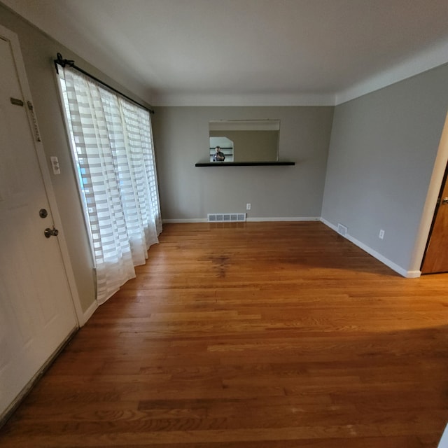 unfurnished living room featuring hardwood / wood-style flooring