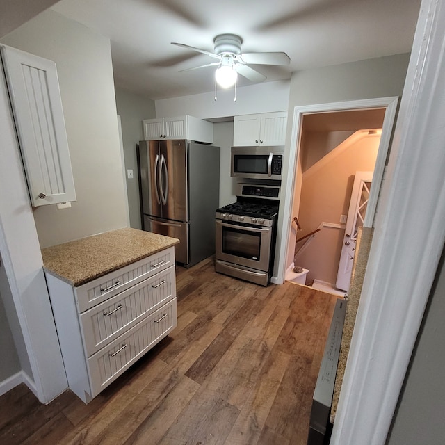 kitchen with white cabinets, ceiling fan, hardwood / wood-style floors, and appliances with stainless steel finishes