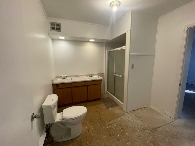 bathroom featuring vanity, toilet, an enclosed shower, and crown molding