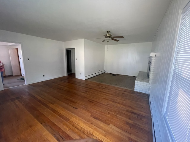 unfurnished living room with ceiling fan, a fireplace, a baseboard radiator, and dark hardwood / wood-style floors