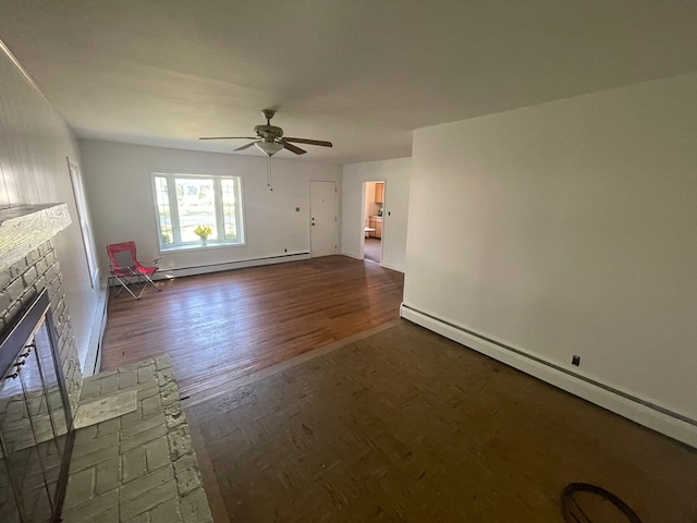 unfurnished living room featuring a fireplace, dark hardwood / wood-style floors, baseboard heating, and ceiling fan