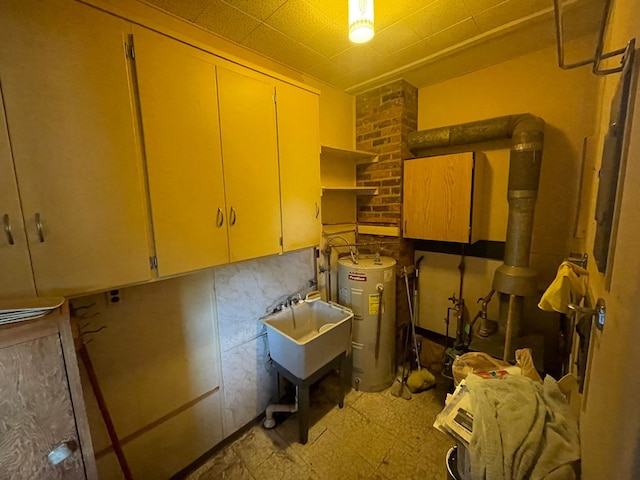 storage room featuring electric water heater and sink