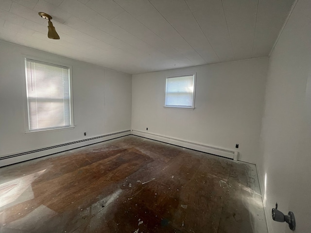 unfurnished room with a baseboard heating unit