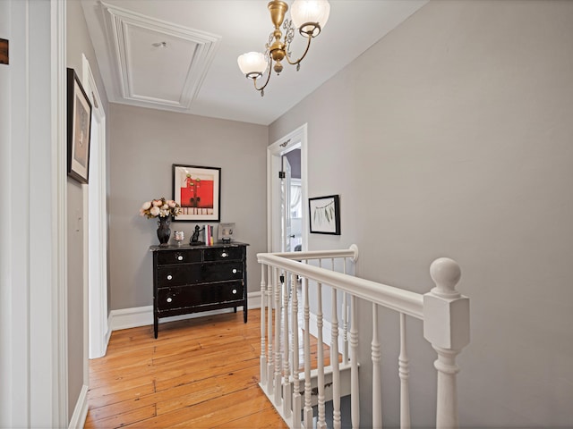 hall featuring hardwood / wood-style floors and a notable chandelier