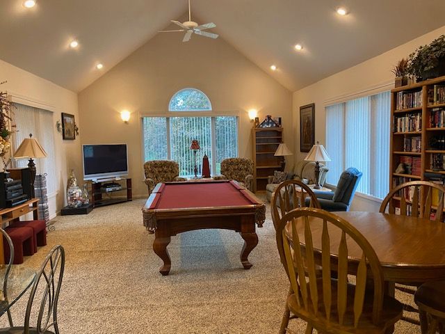 playroom with light carpet, high vaulted ceiling, ceiling fan, and pool table