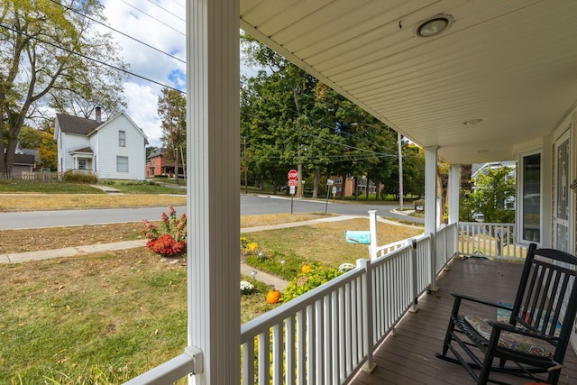 wooden deck with a porch and a yard