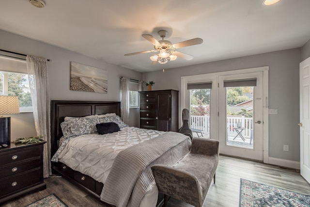 bedroom with hardwood / wood-style floors, ceiling fan, and access to outside