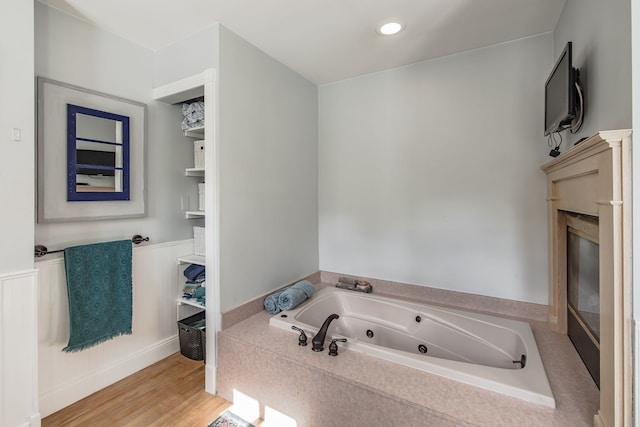 bathroom featuring wood-type flooring and a bathtub