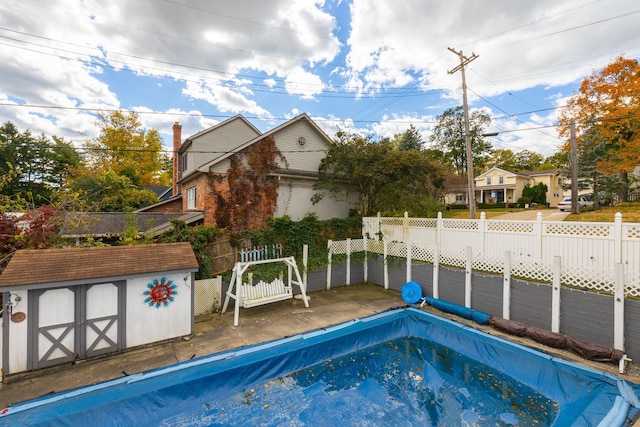 view of pool featuring a storage shed