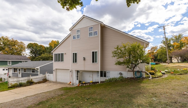 view of side of home with a garage and a lawn