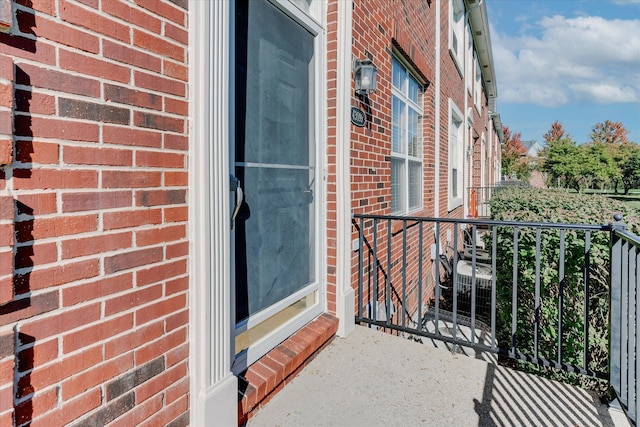 view of exterior entry with a balcony