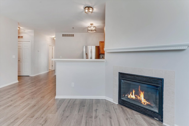 interior space with a fireplace and light wood-type flooring