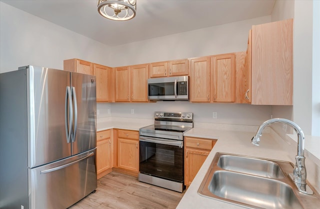 kitchen featuring light hardwood / wood-style floors, light brown cabinetry, sink, and appliances with stainless steel finishes