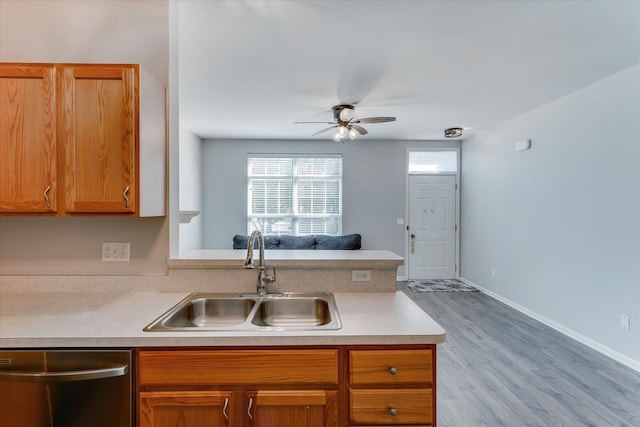 kitchen with light hardwood / wood-style floors, stainless steel dishwasher, ceiling fan, and sink