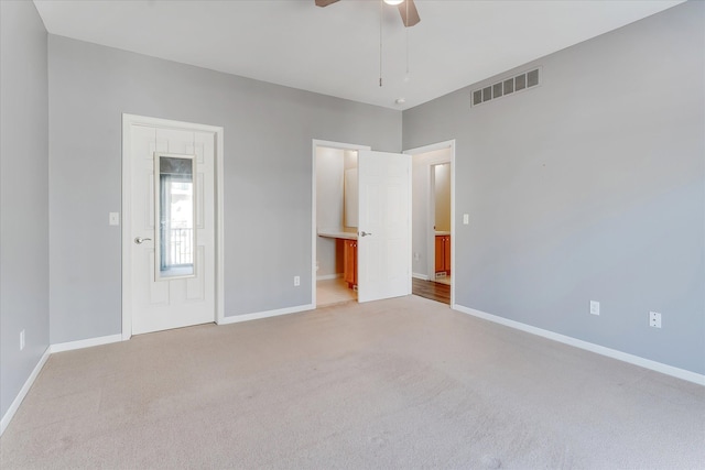 carpeted spare room with ceiling fan