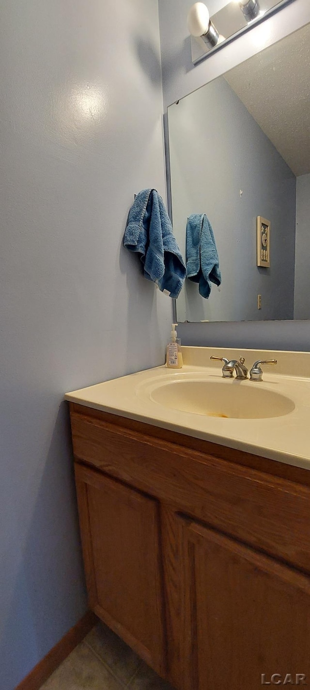 bathroom featuring tile patterned flooring and vanity