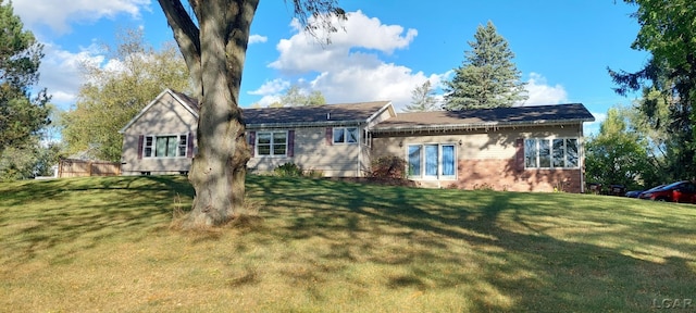 back of house featuring a yard