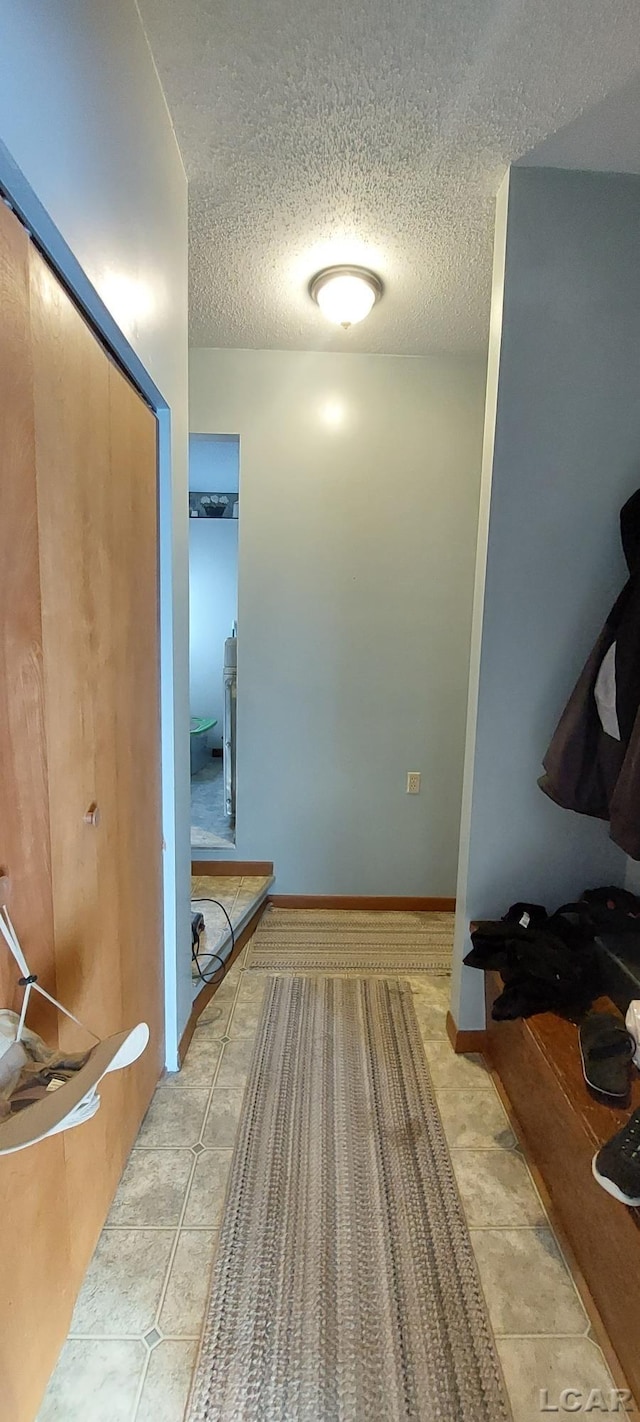 interior space featuring tile patterned flooring and a textured ceiling