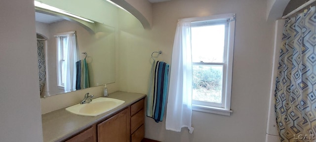 bathroom with a shower with shower curtain and vanity