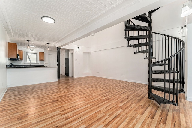 unfurnished living room with light hardwood / wood-style floors