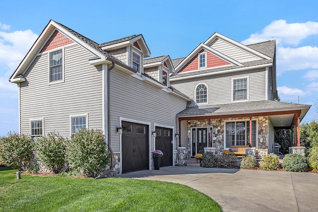 view of front of property with a garage and a front lawn