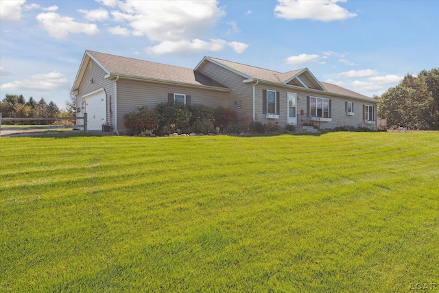 ranch-style home with a garage and a front yard