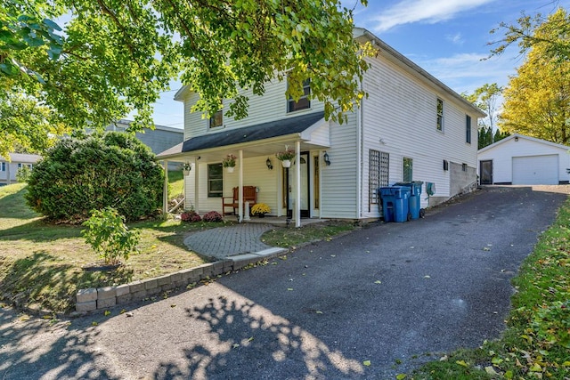 view of front facade with a porch, a garage, and an outdoor structure