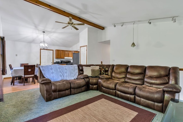 living room with beamed ceiling, high vaulted ceiling, track lighting, ceiling fan with notable chandelier, and hardwood / wood-style flooring