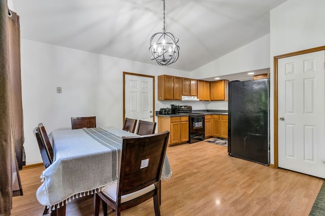 dining space with a chandelier, high vaulted ceiling, and light hardwood / wood-style flooring