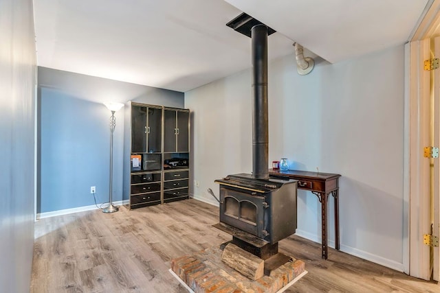 living room with hardwood / wood-style floors and a wood stove