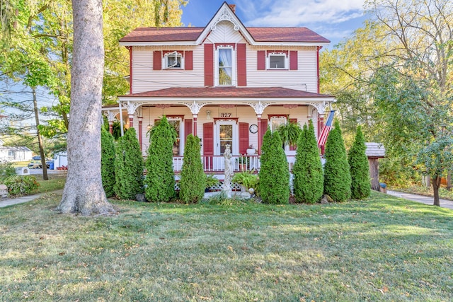 327 Reid Rd, Grand Blanc, MI 48439 - view of front facade featuring a porch and a front lawn