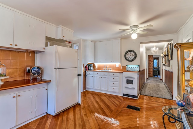 327 Reid Rd, Grand Blanc, MI 48439 - kitchen with light wood-type flooring, visible vents, white cabinetry, white appliances, and ceiling fan with notable chandelier