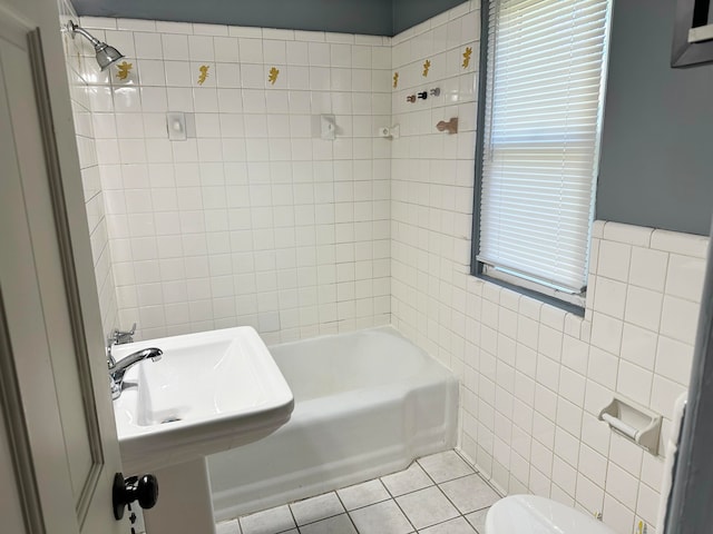 bathroom featuring tile patterned floors, toilet, tile walls, and tiled shower / bath