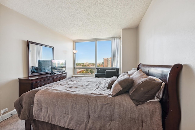 bedroom featuring carpet and a textured ceiling