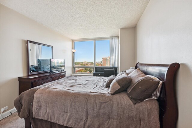 3320 Spinnaker Ln Unit 11B, Detroit, MI 48207 - carpeted bedroom with a textured ceiling and multiple windows