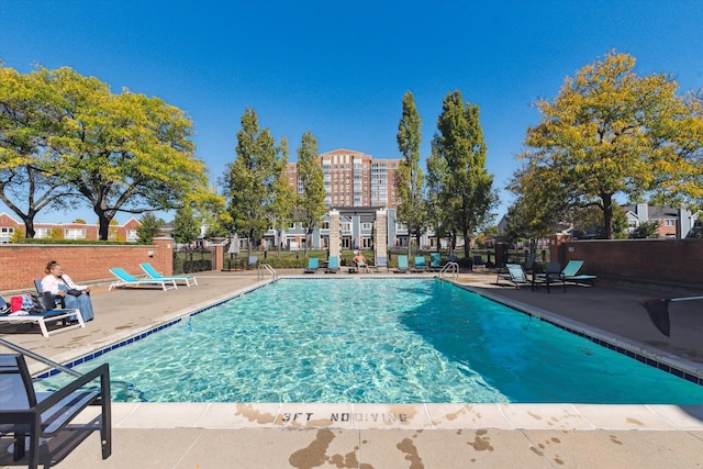 view of swimming pool with a patio