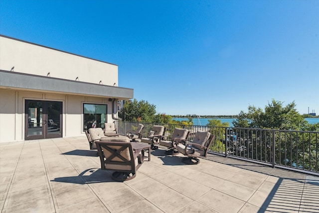 view of patio / terrace with french doors and a water view