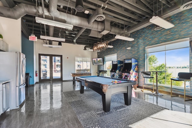 recreation room with pool table, a high ceiling, and french doors