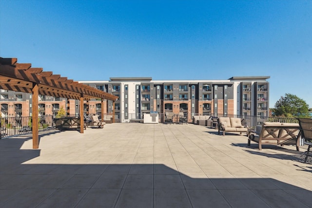 view of community featuring an outdoor living space and a pergola