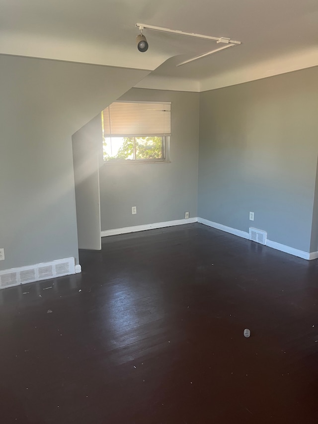 empty room featuring dark wood-type flooring