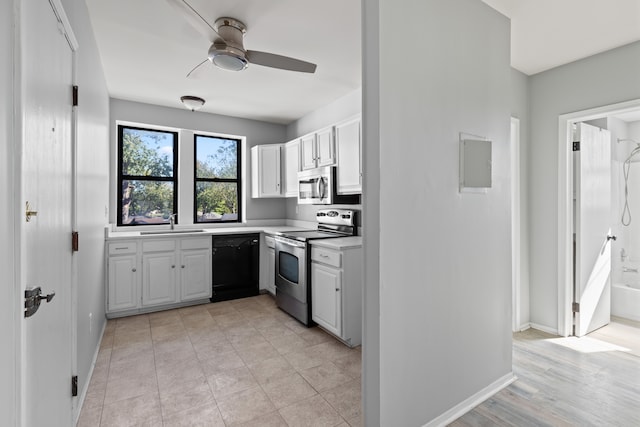 kitchen featuring white cabinets, stainless steel appliances, ceiling fan, and sink