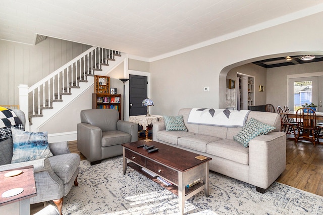 living room with hardwood / wood-style flooring and wooden walls