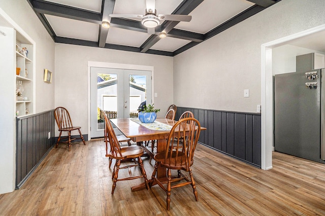 dining area featuring beamed ceiling, french doors, light wood-type flooring, and coffered ceiling